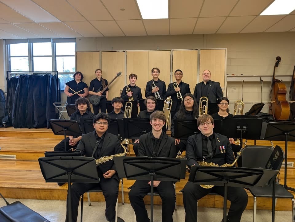 Image of the BHS jazz band and Mr. McGrath posing with their instruments.  