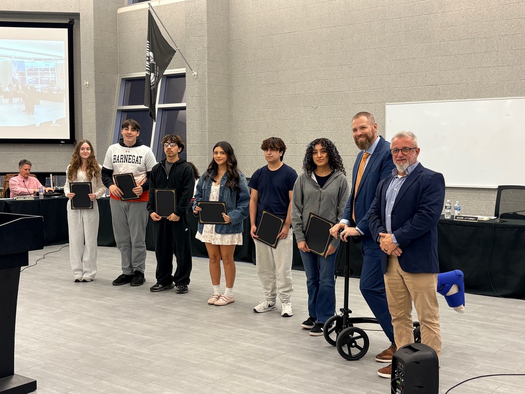 Image of the Juniors who attended the BOE meeting and received the Seal of Biliteracy recognition holding their certificates posing with the Superintendent and Board President.  