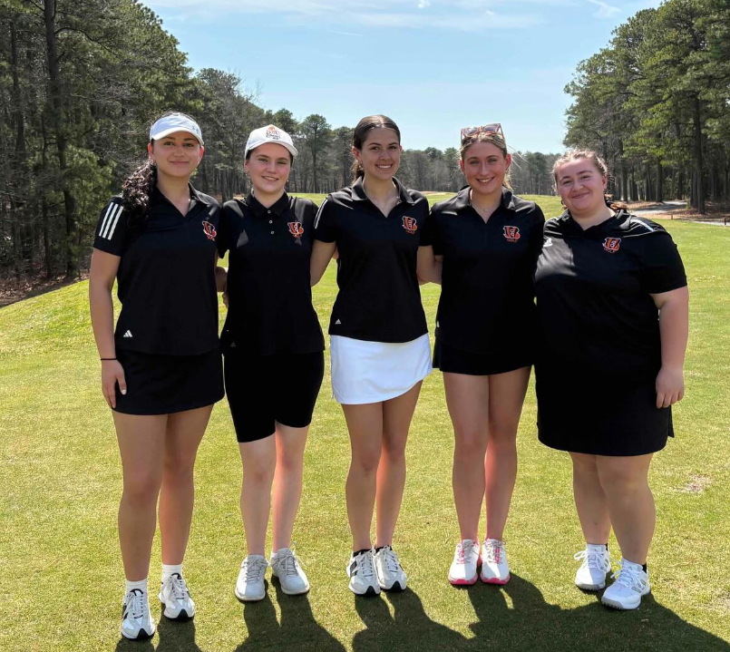 Image of the five girls posing together on the fairway. 
