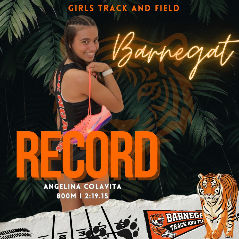 Image of Angelina Colavita holding her track shoes over her arm with all of the information for her new school record. 