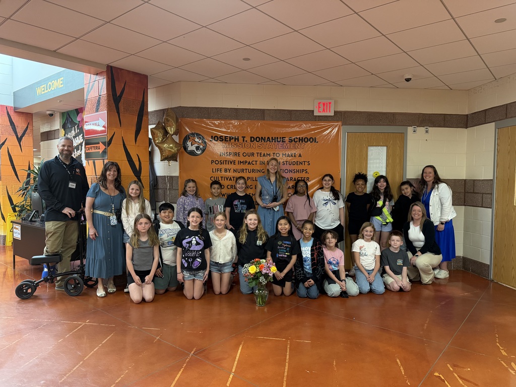 Image of Jennifer posing with the Superintendent, district and building administrators, and students in her No Place For Hate club. 
