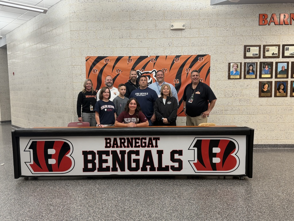 Image of Madysen posing with her coach, family, building and district administrators. 