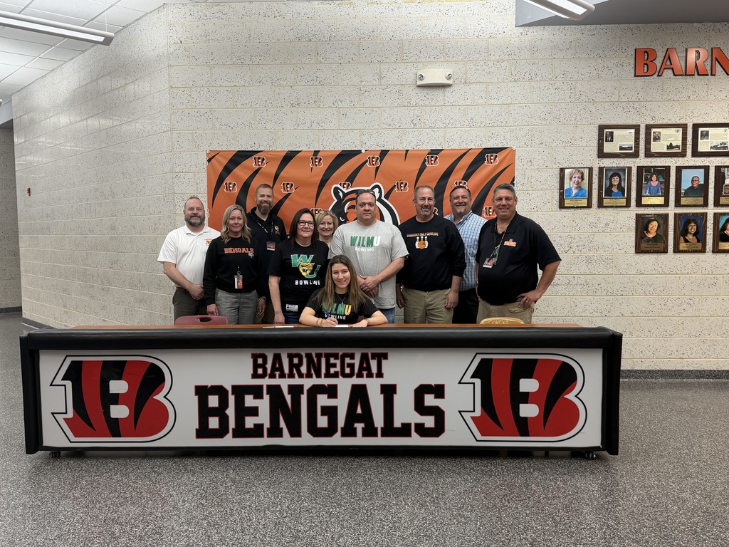 Image of Kaylee posing with her coach, family, and building & district administrators. 