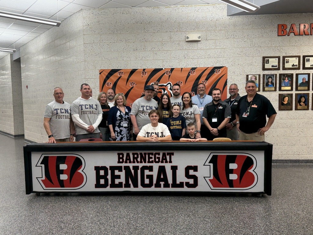 Image of Jack posing with his coaches, family, and building & district administrators. 