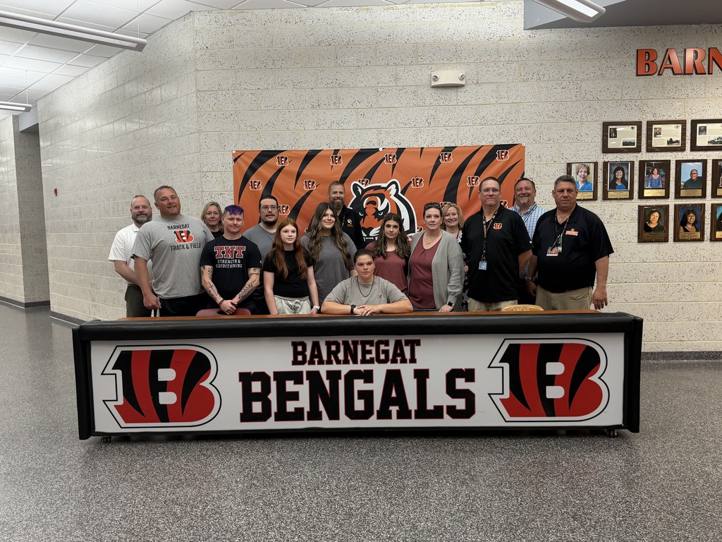 Image of Ellie posing with her coaches, family, and building & district administrators. 
