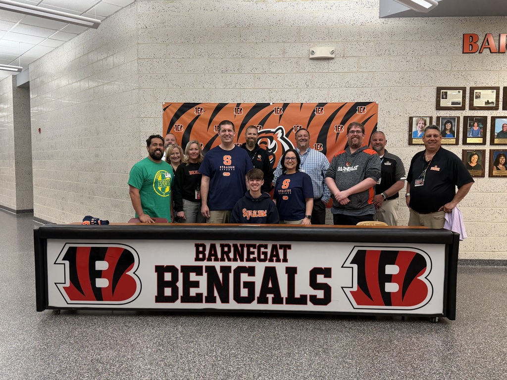 Image of Nicholas posing with his coaches, family, and building & district administrators. 