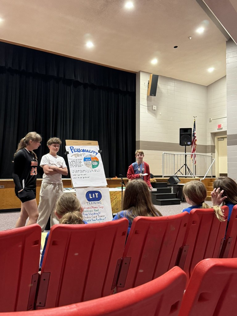 Image of a group of three ROBMS students teaching an activity to the RLHS  students. 