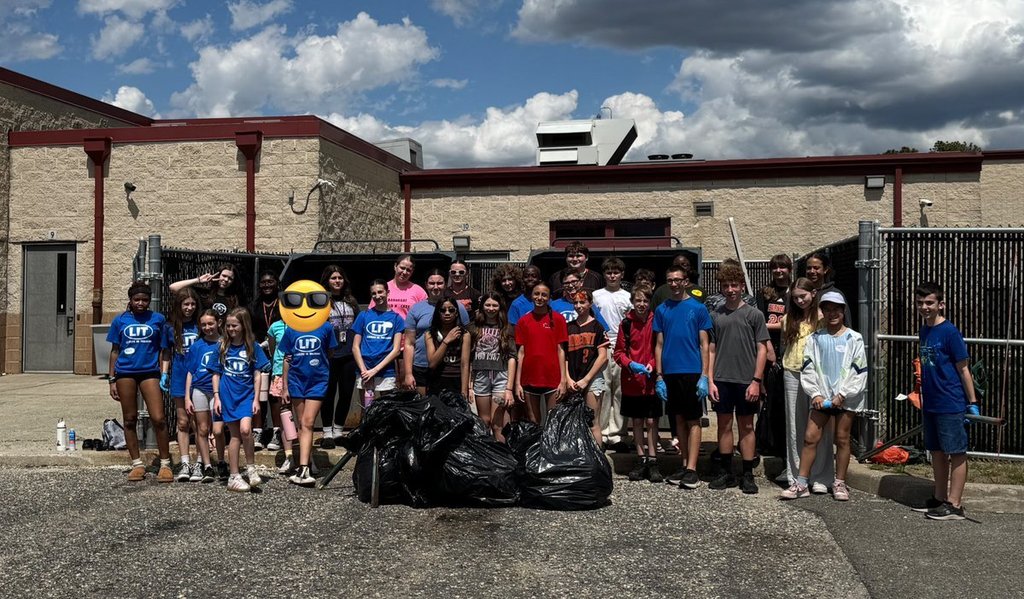 Image of the ROBMS NJHS members, ROBMS LIT's, and RLHS LIT's posing together with the trash bags and items that were collected during the campus cleanup. 