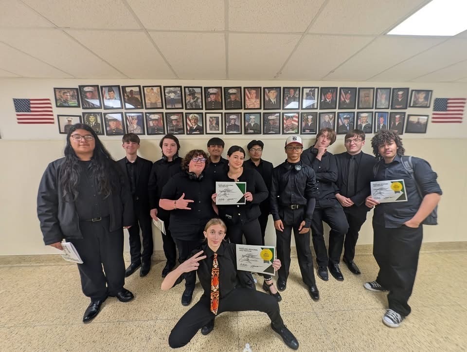 Image of the BHS Jazz Ensemble posing together holding the three certificates that were earned from their performance.