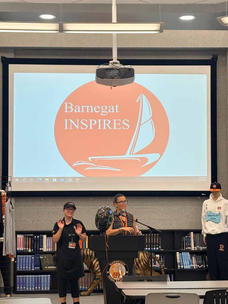 Image of the Ms. Sciallo, the CLAWS Program teacher/coordinator, speaking to the audience about the program with a former student standing next to her. 