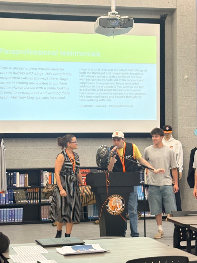 Image of a male BHS CLAWS student speaking to the audience about his experience in the program. 