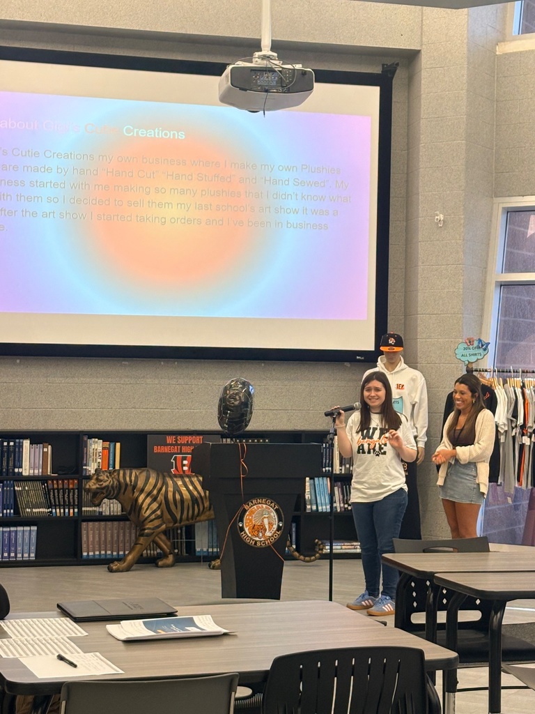 Image of a female BHS CLAWS student speaking to the audience about her experience in the program. 