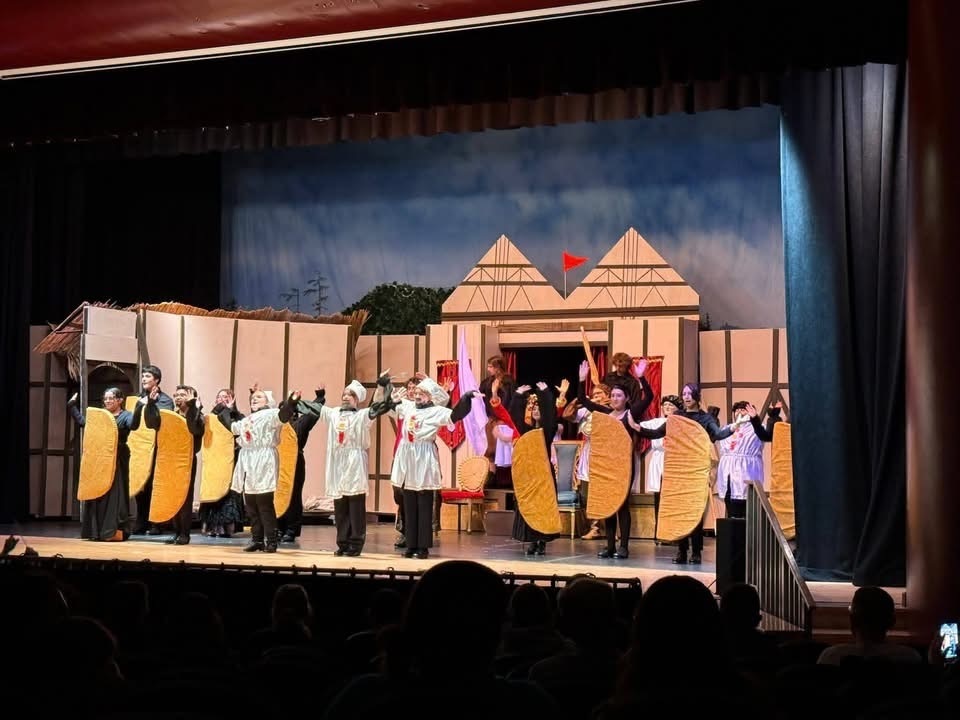 Image of the cast of Something Rotten performing a scene on stage in costume. 