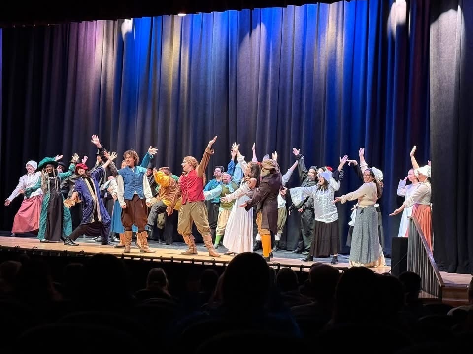 Image of the cast of Something Rotten performing a scene on stage in costume. 