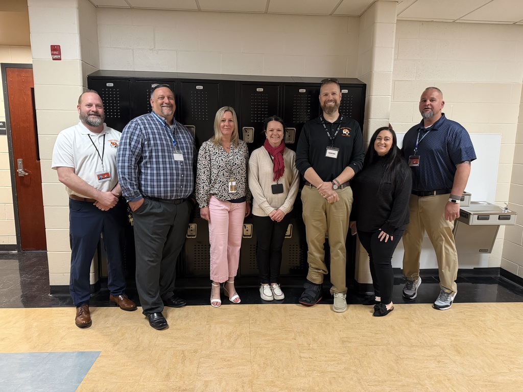 Image of Kristen posing with the Superintendent, district, and building administrators. 