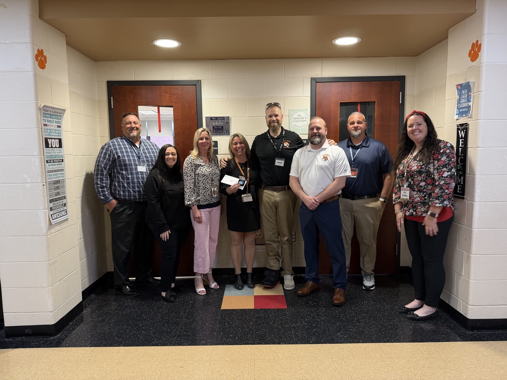 Image of Barbara posing with the Superintendent, district, and building administrators. 