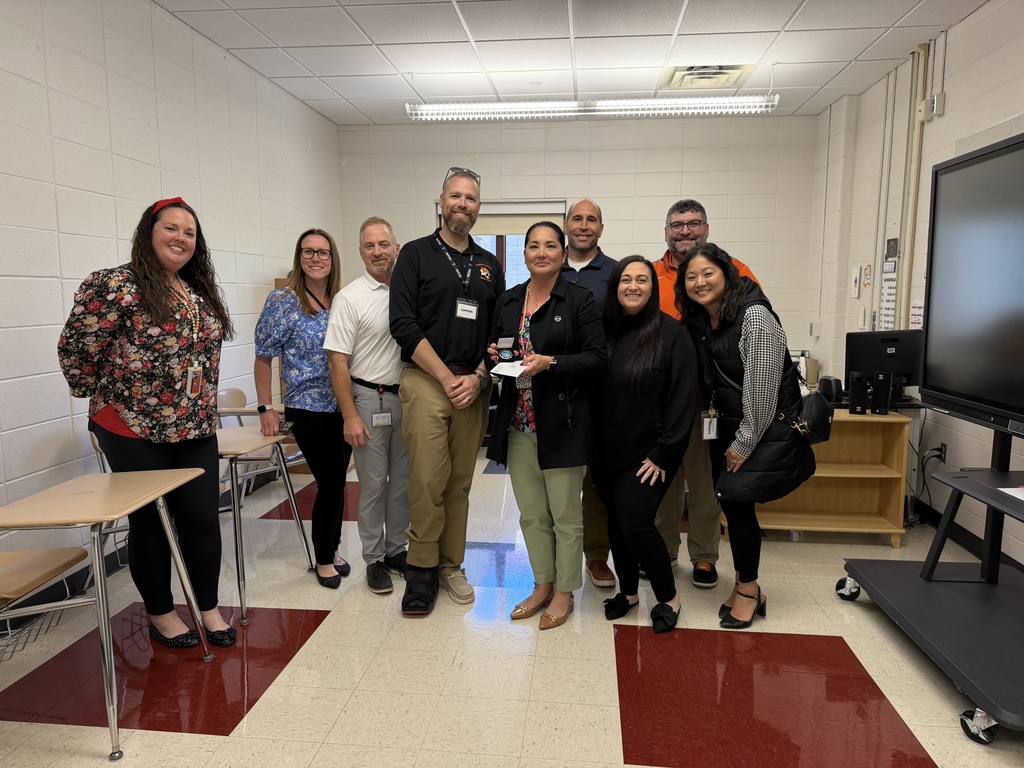 Image of Jennifer posing with the Superintendent, district, and building administrators. 