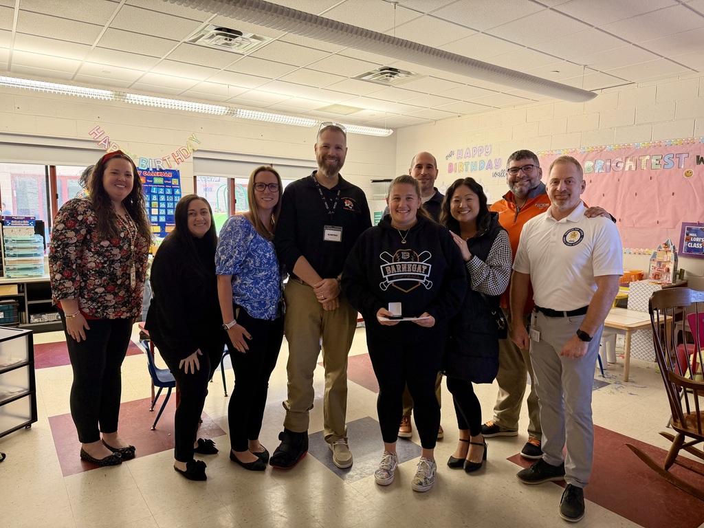 Image of Lori posing with the Superintendent, district, and building administrators. 