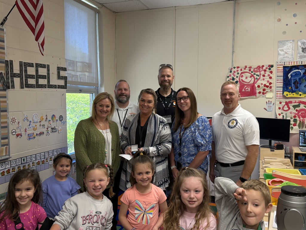 Image of Ashley posing with the Superintendent, district, and building administrators. 
