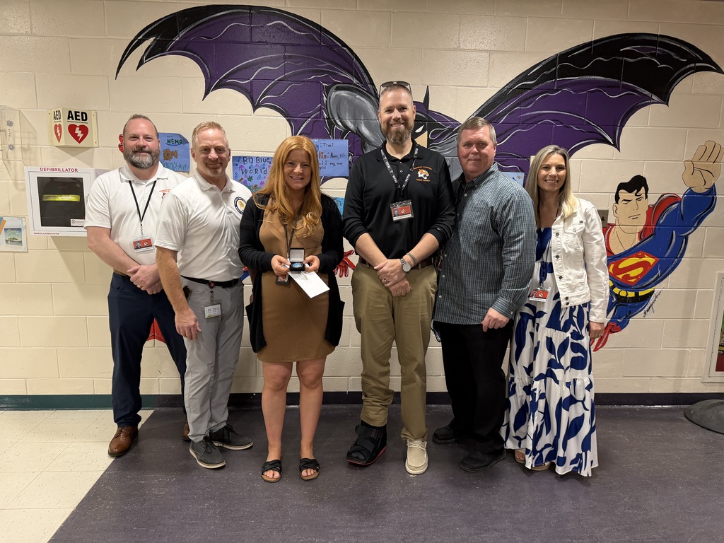 Image of Ashley posing with the Superintendent, district, and building administrators. 