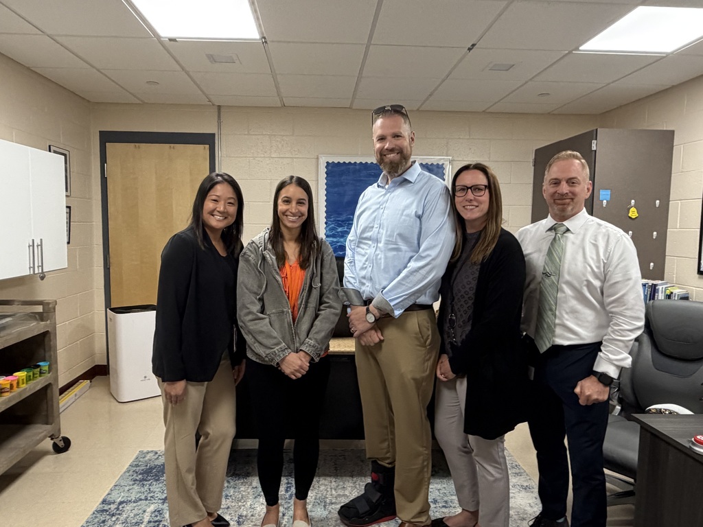 Image of Jackie posing with the Superintendent, district, and building administrators. 