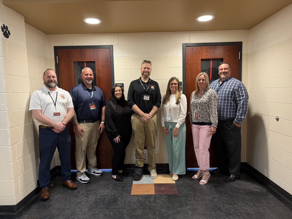 Image of Jennifer posing with the Superintendent, district, and building administrators. 