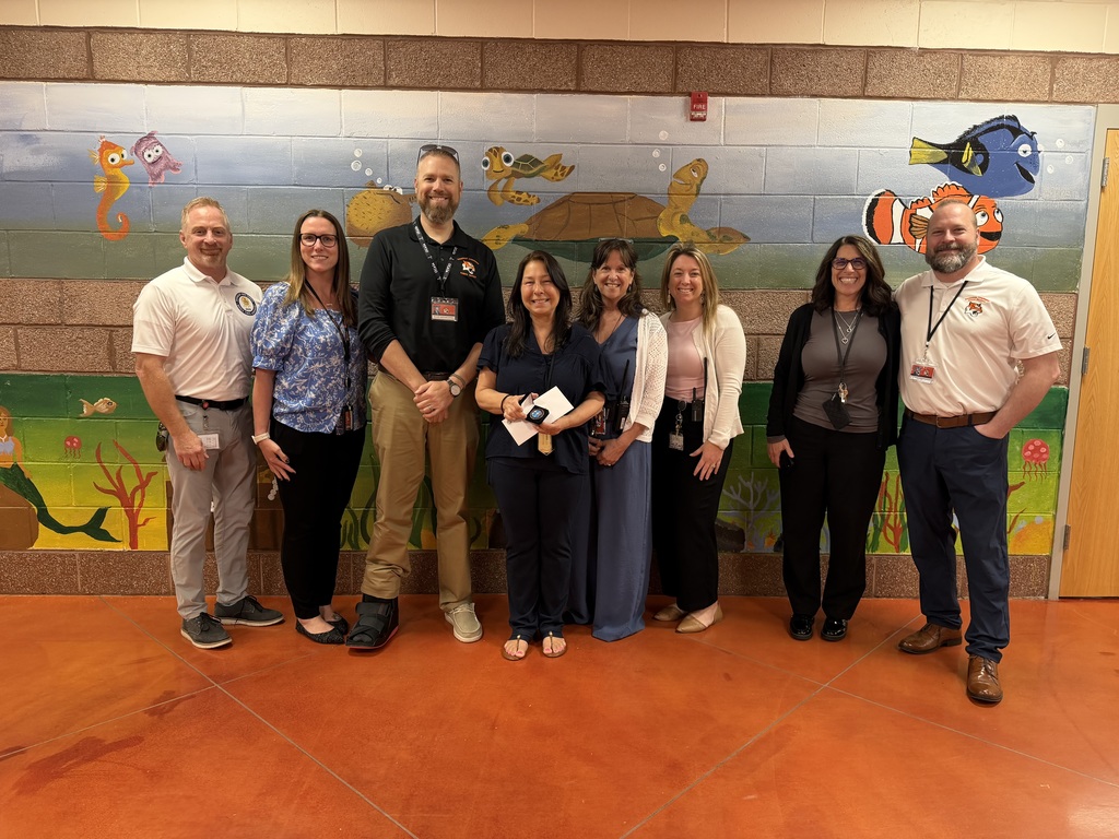 Image of Cindy posing with the Superintendent, district, and building administrators. 