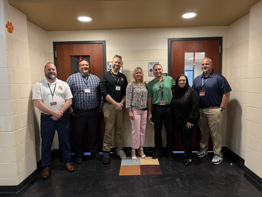 Image of Joseph posing with the Superintendent, district, and building administrators. 