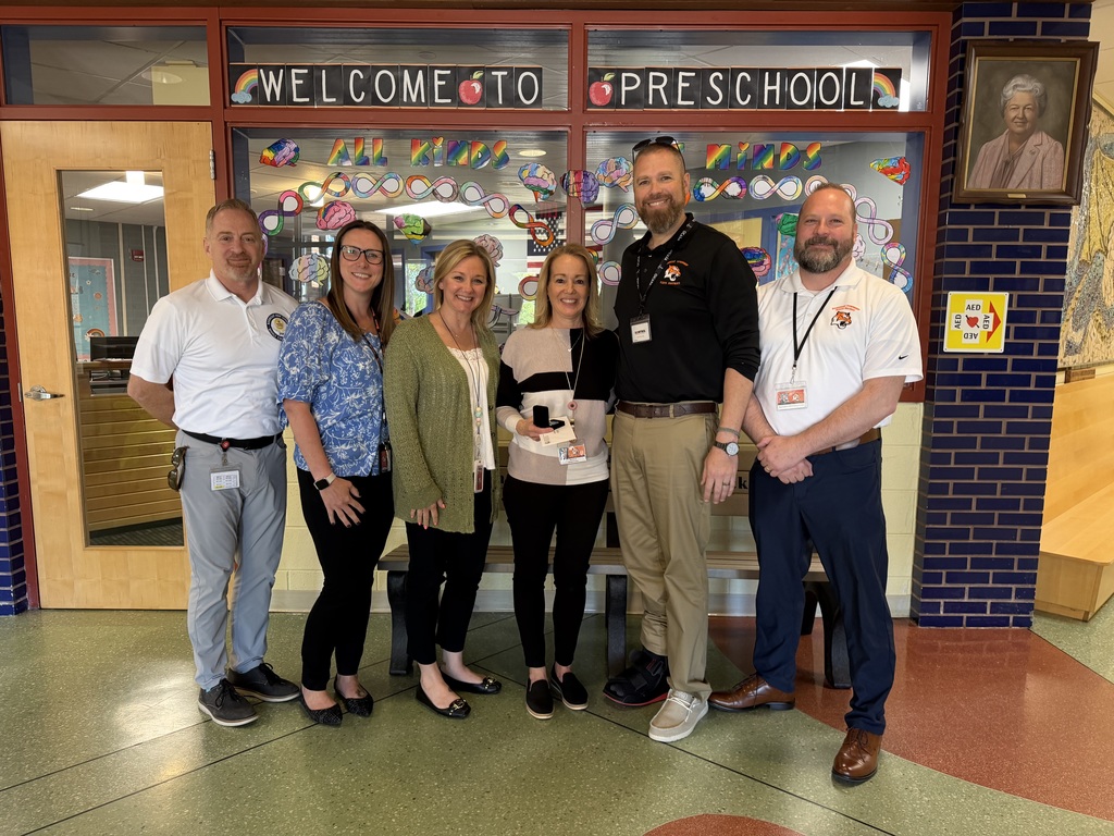Image of Joann posing with the Superintendent, district, and building administrators. 
