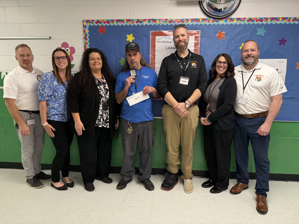 Image of Steven posing with the Superintendent, district, and building administrators. 