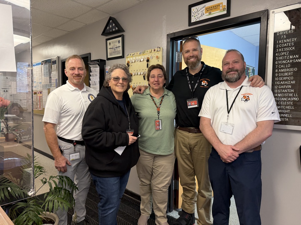 Image of Diane posing with the Superintendent, district, and building administrators. 