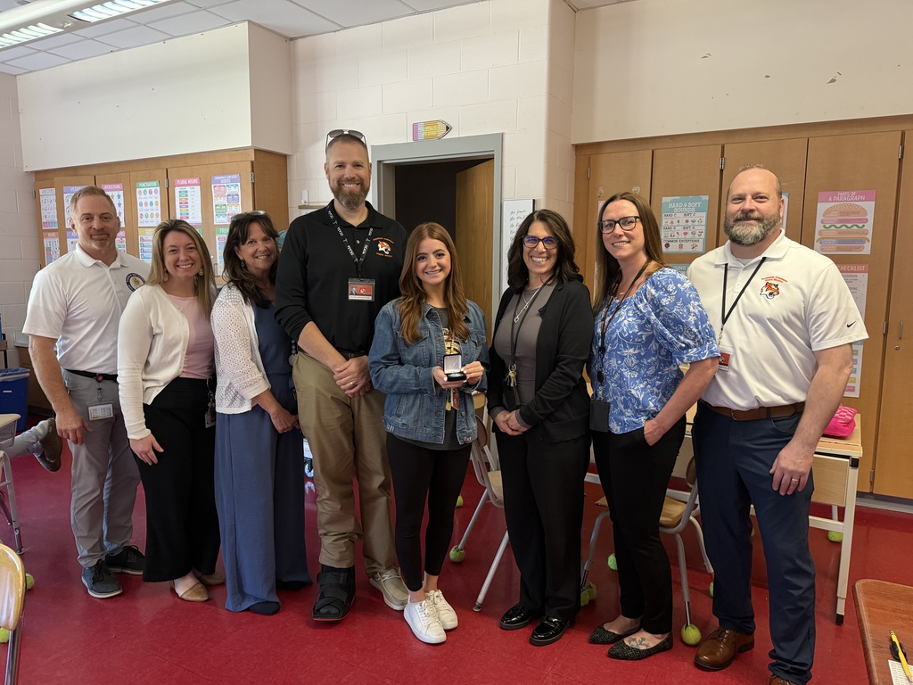 Image of Nicole posing with the Superintendent, district, and building administrators. 