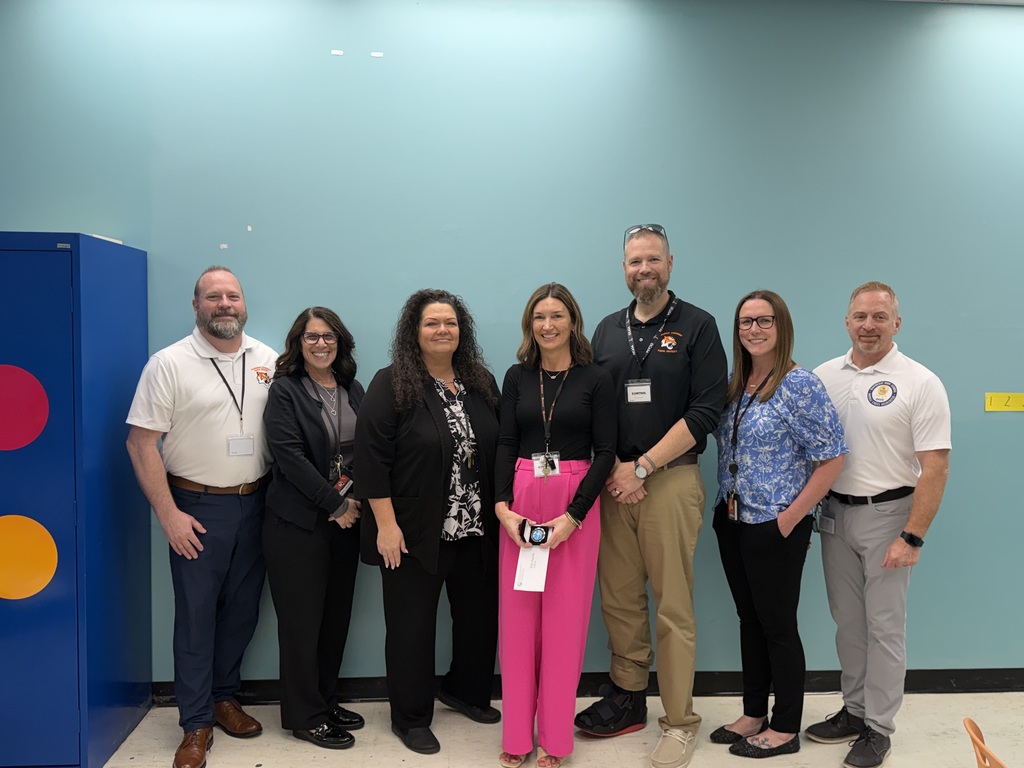 Image of Beth posing with the Superintendent, district, and building administrators.