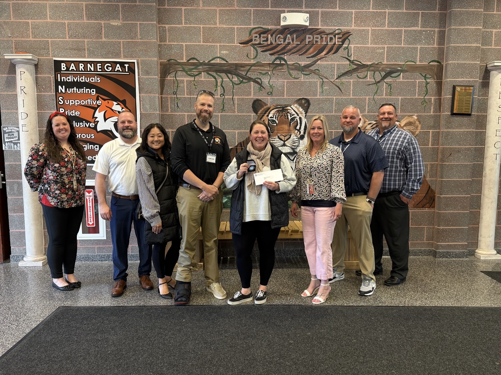 Image of Nina posing with the Superintendent, district, and building administrators. 