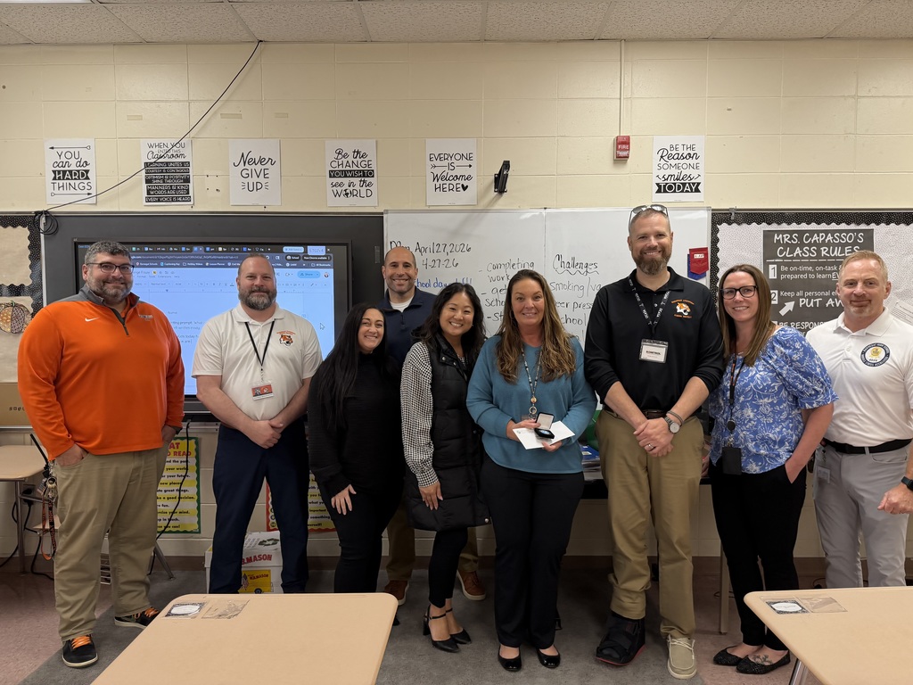 Image of Renee posing with the Superintendent, district, and building administrators. 