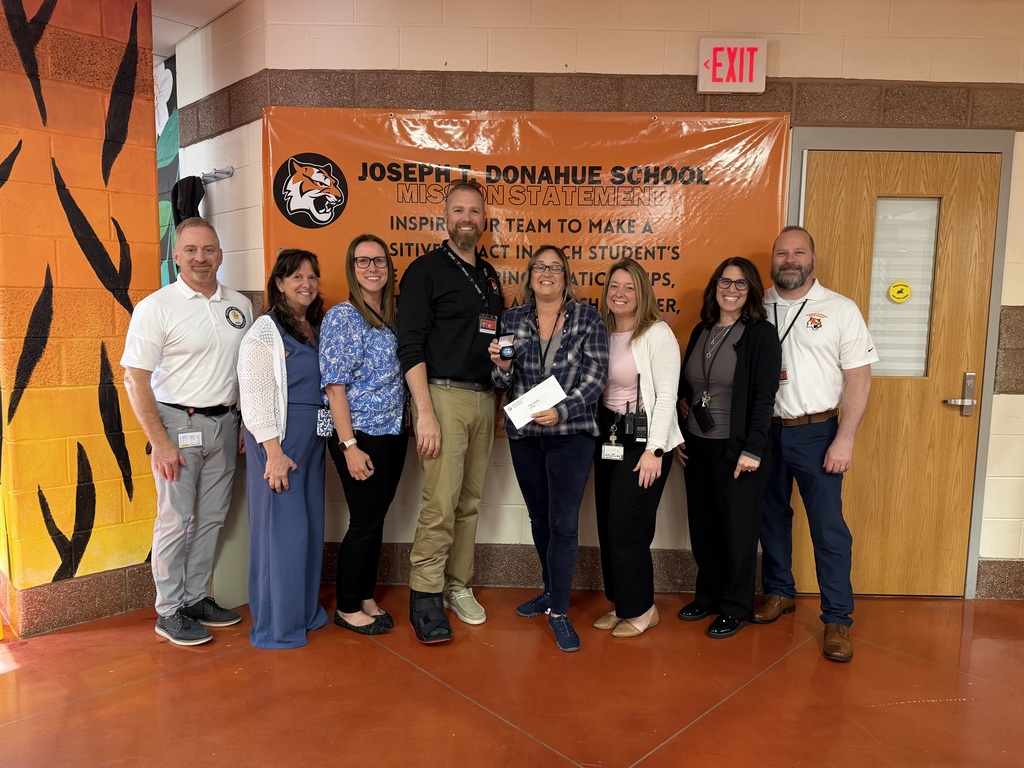Image of Pamela posing with the Superintendent, district, and building administrators. 