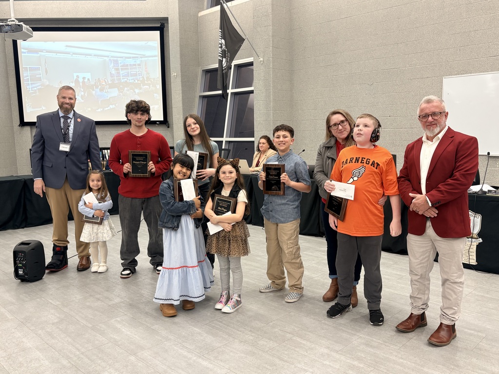Image of the April UPstander award recipients holding their plaques and posing with the Superintendent and BOE President. 