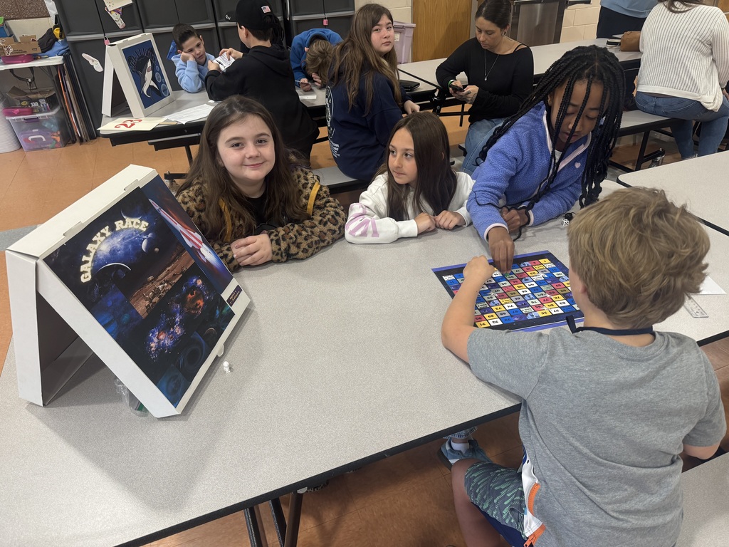 Image of 3rd grade students playing a game that one of the G&T students made. 