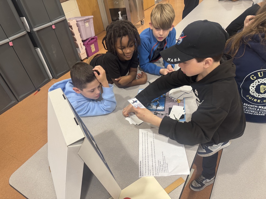 Image of 3rd grade students playing a game that one of the G&T students made. 