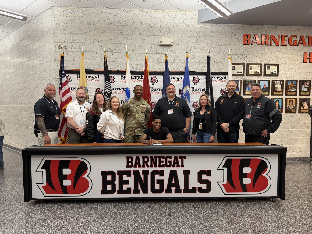 Image of Abdul posing with the Superintendent, district & building administrators, school counselor, and recruiter. 