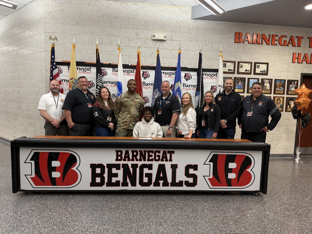Image of Ajhon posing with the Superintendent, district & building administrators, school counselor, and recruiter. 