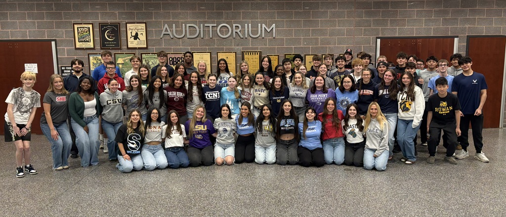 Image of the seniors posing together wearing their college/military clothing. 