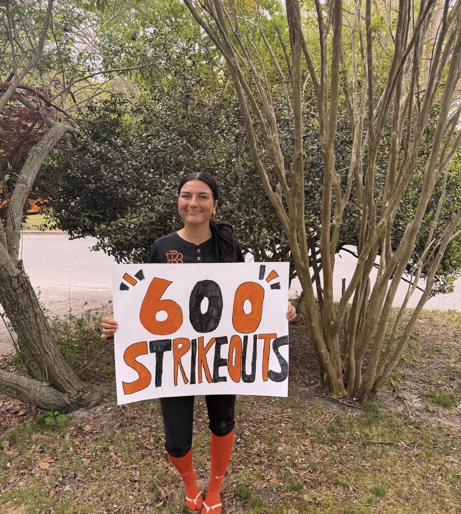 Image of Gianna posing holding a sign that says 600 strikeouts. 