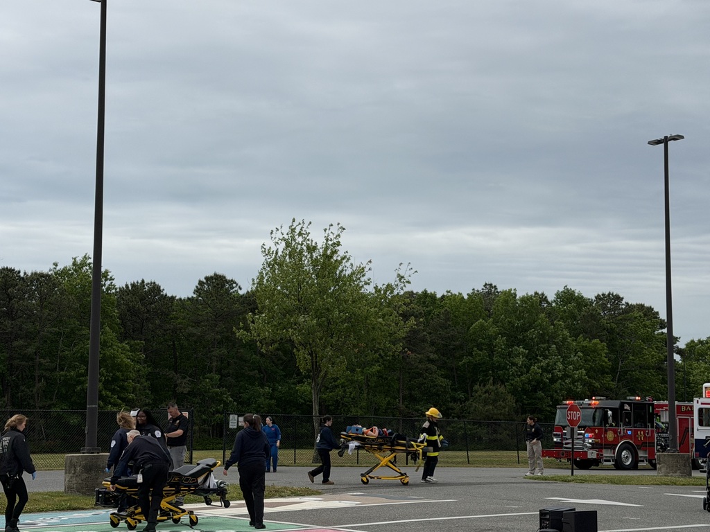 Image of a student actor being taken away on a stretcher.