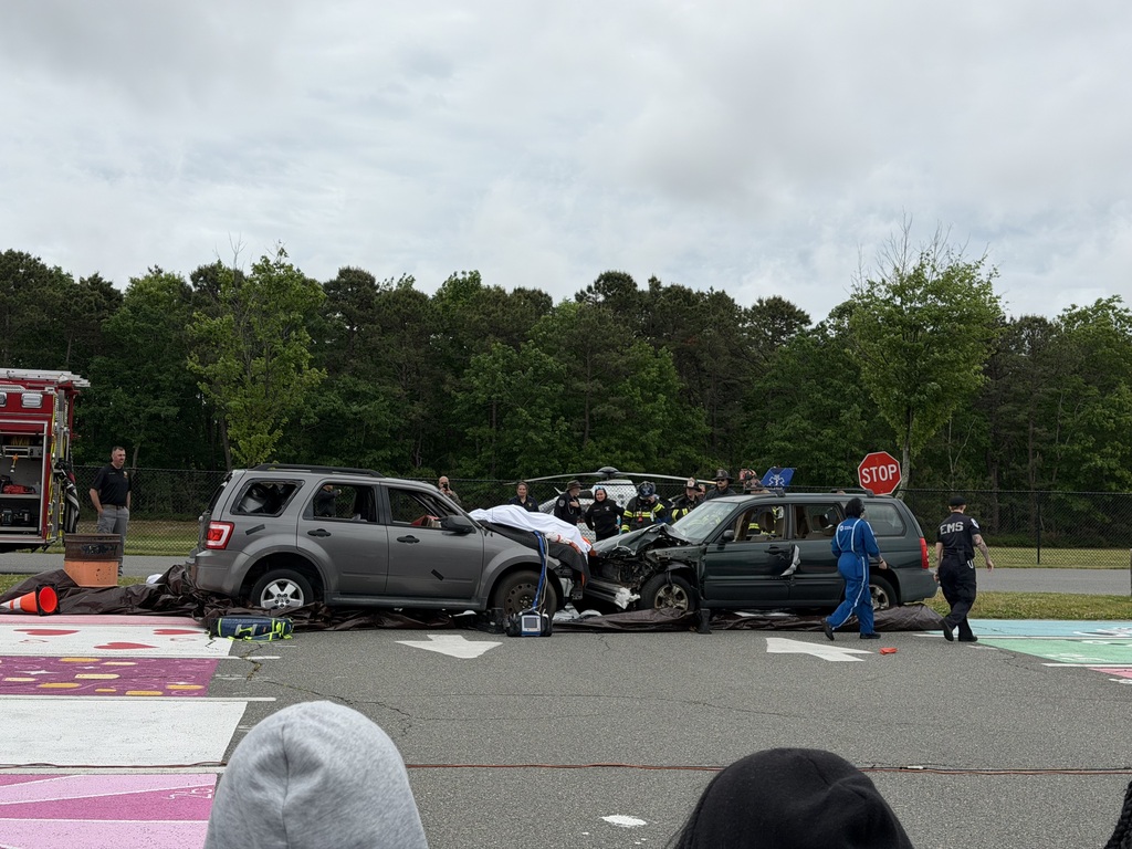 Image of the final scene after a white cloth is put over the student actor on the hood of the car.
