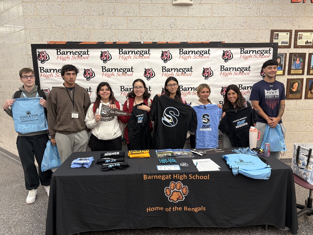 Image of the 8 seniors who will be attending Stockton University in the fall displaying their Stockton swag.