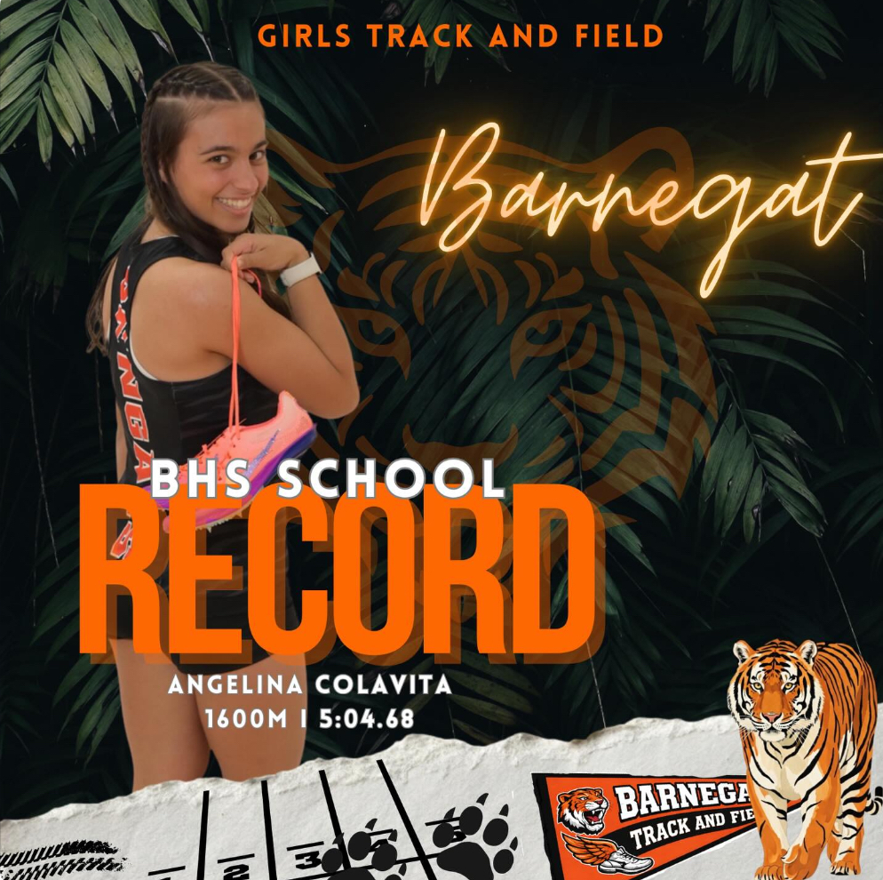 Image of Angelina Colavita holding her track shoes over her arm with all of the information for her new school record. 