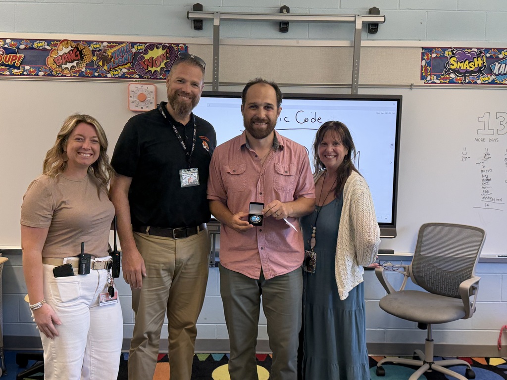 Image of Erik posing with the Superintendent, Principal, and Vice Principal.