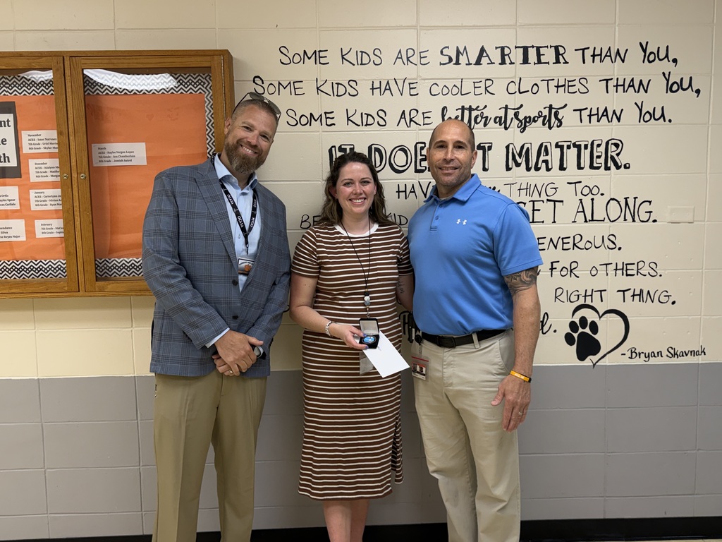 Image of Sarah posing with the Superintendent and Principal.
