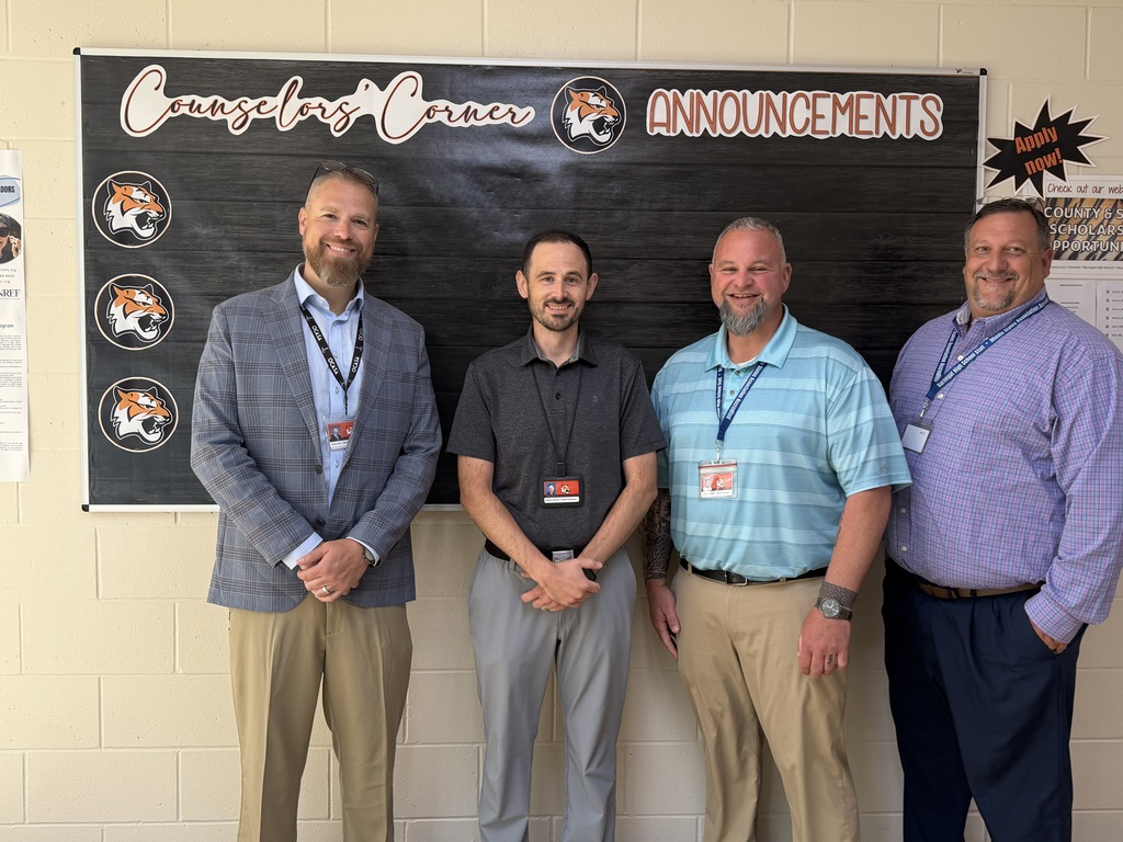 Image of Jeff posing with the Superintendent, Principal, and Vice Principal.